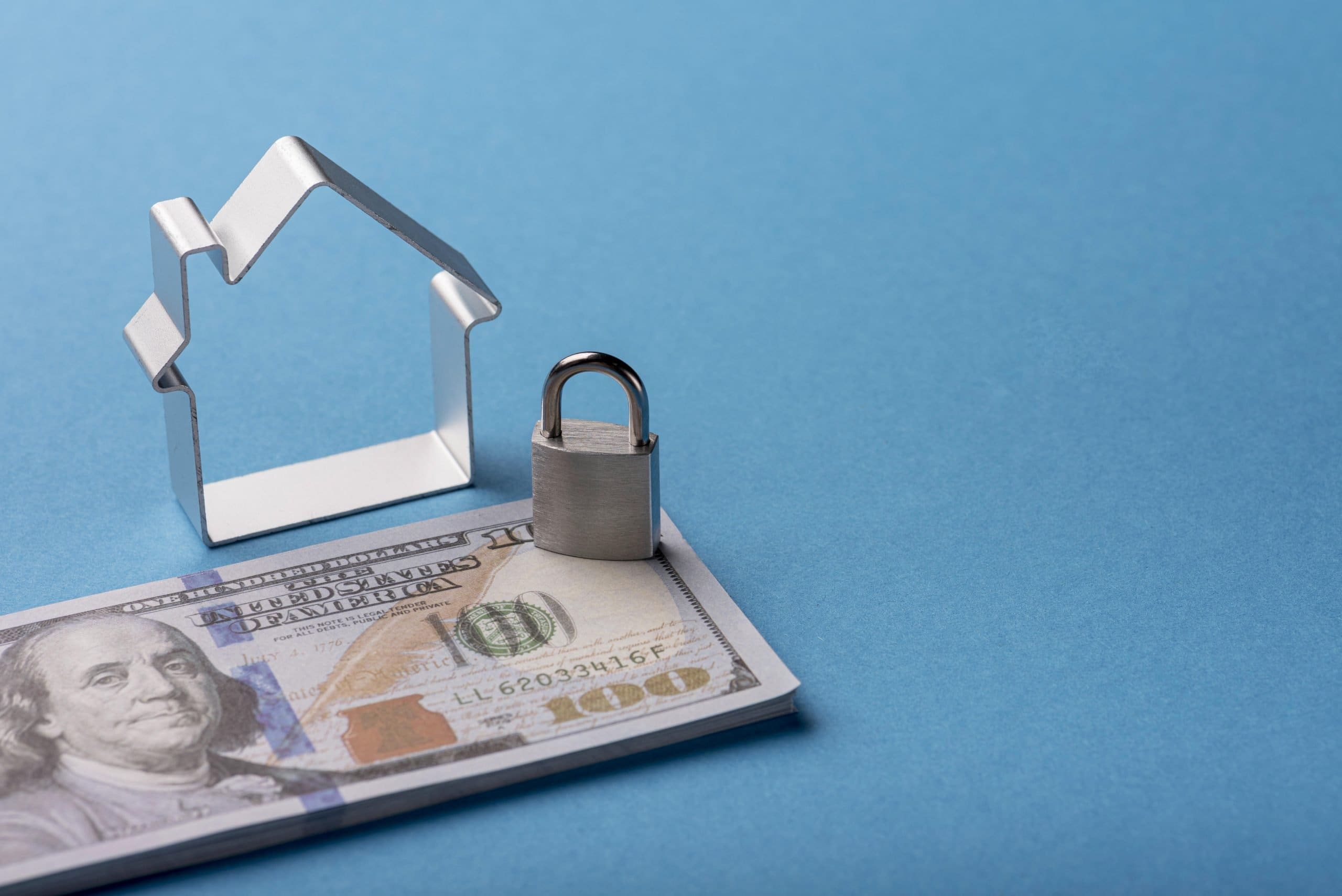 high angle banknotes with house lock scaled - How Property Management Can Surprisingly Save You Money